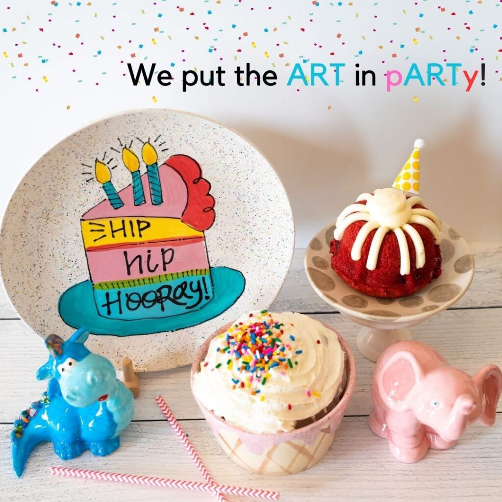 Colorful birthday plate, cupcakes, and painted ceramic figurines at Bisque It Studio party setup